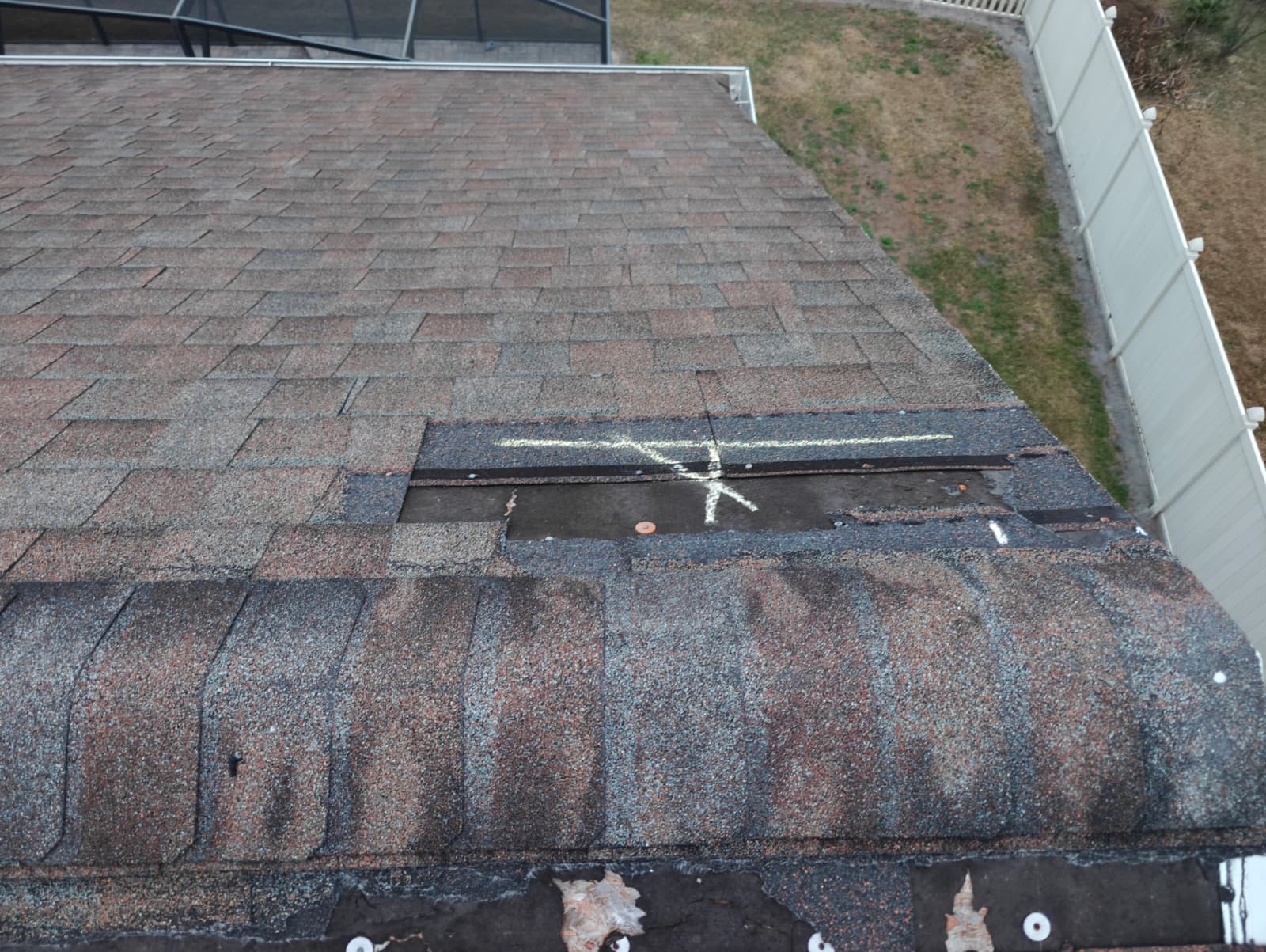 Missing shingles exposing underlayment at the roof eave