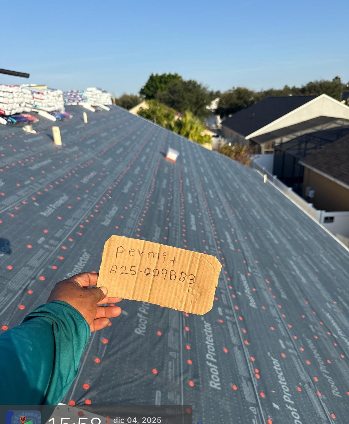 Dried-in roof with premium shingles staged and ready to install