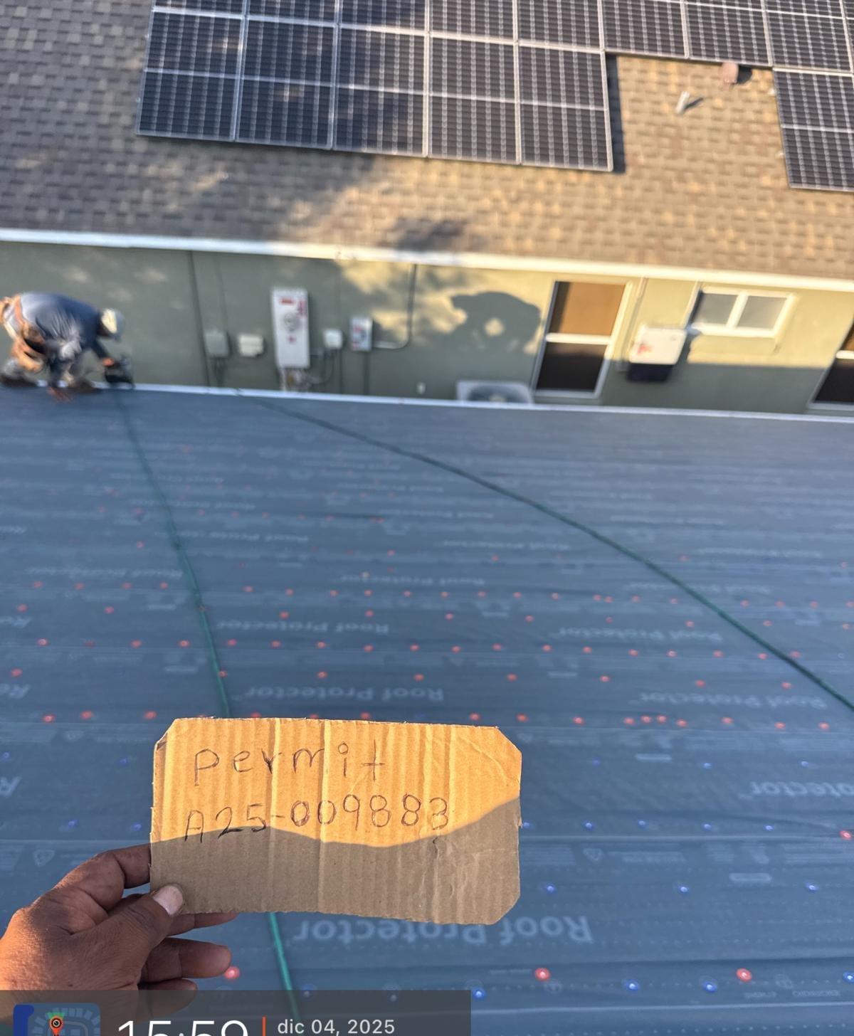 Roof underlayment installed around existing solar panels during a re-roof