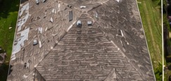 Storm-damaged roof before restoration